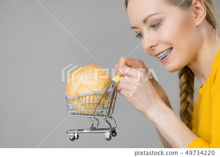 Woman holding shopping cart with bread 49734220