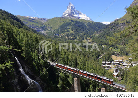 Mountain climber on the Matterhorn and bridge Mountain climber on the Matterhorn and bridge 49735515