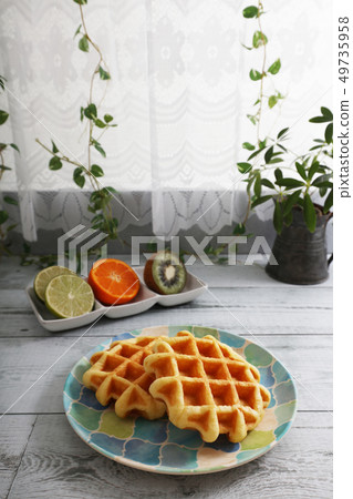Delicious waffles and fruits Delicious waffles and fruits 49735958