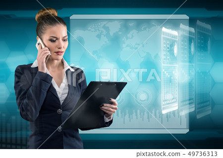 Young business lady speaks on the phone and works in futuristic office Young business lady speaks on the phone and works in futuristic office 49736313