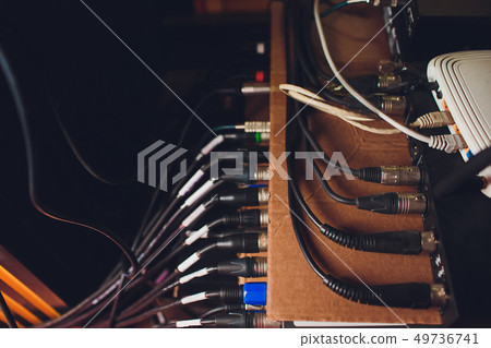 Audio jack cable connected at rear end of mixer at broadcasting,shallow depth of field. Audio jack cable connected at rear end of mixer at broadcasting,shallow depth of field. 49736741