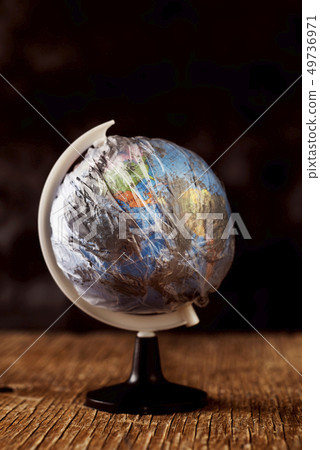 world globe wrapped in a dirty plastic world globe wrapped in a dirty plastic 49736971