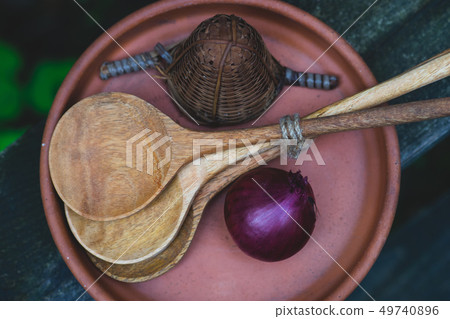 Onion with spoons in a plate Onion with spoons in a plate 49740896