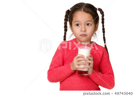 little child girl holding glass of milk on white background 49743040
