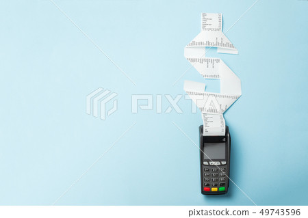 Terminal cash register machine POS for payments and long roll paper cash tape in shape of dollar 49743596