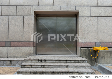 sidewalk by street wall & door sidewalk by street wall & door 49745063