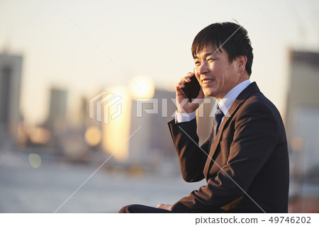 Middle businessman sunset smartphone call 49746202