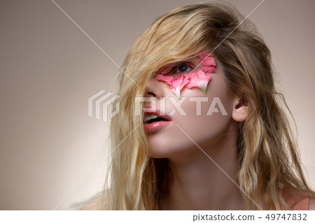 Tender young model having blonde wavy hair on her face 49747832