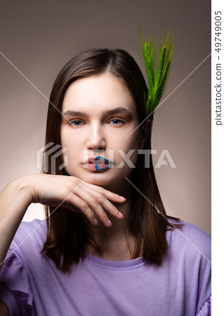 Tender blue-eyed model moving her hand while posing Tender blue-eyed model moving her hand while posing 49749005