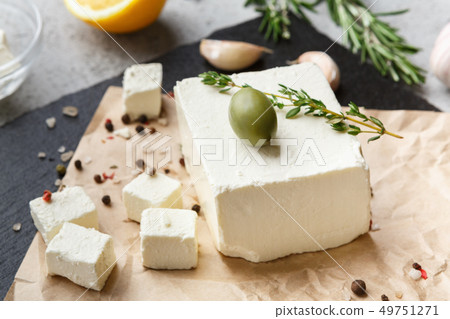 Cubes of feta cheese and spices on board 49751271