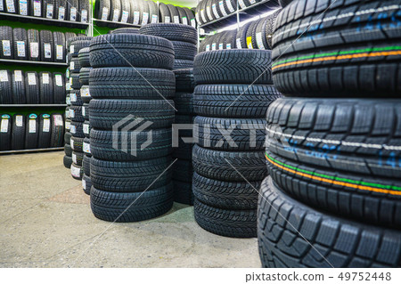 Rack with variety of new car tires in automobile store Rack with variety of new car tires in automobile store 49752448