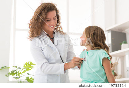 Woman pediatrician examining girl in office in clinic Woman pediatrician examining girl in office in clinic 49753114