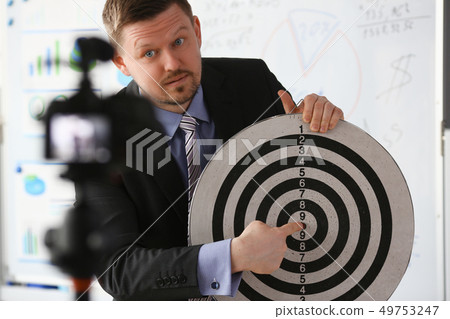 Male millennial vlogger hold target darst 49753247