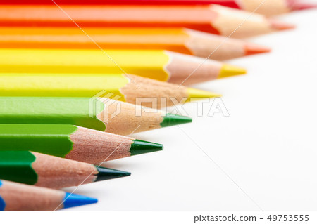 Set of multicoloured pencils lying on white table 49753555