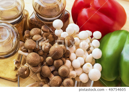 White small mushrooms . Small white and brown mushrooms on the table.White beech mushrooms or White small mushrooms . Small white and brown mushrooms on the table.White beech mushrooms or 49754605