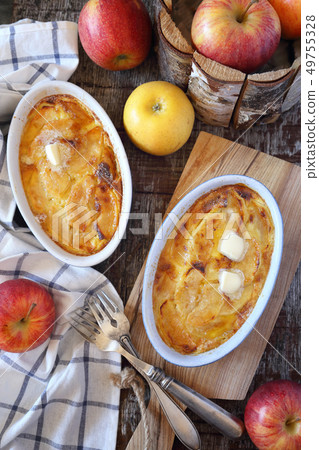 Apple clafoutis in two ceramic dish for breakfast Apple clafoutis in two ceramic dish for breakfast 49755328