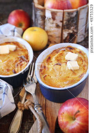 Apple clafoutis in two ceramic dish for breakfast Apple clafoutis in two ceramic dish for breakfast 49755329