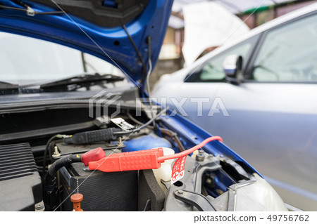 Car battery run-up and first aid Jumping start with booster cable Car battery run-up and first aid Jumping start with booster cable 49756762