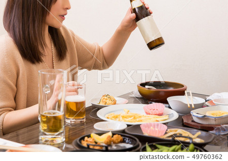 A woman drinking alcohol 49760362