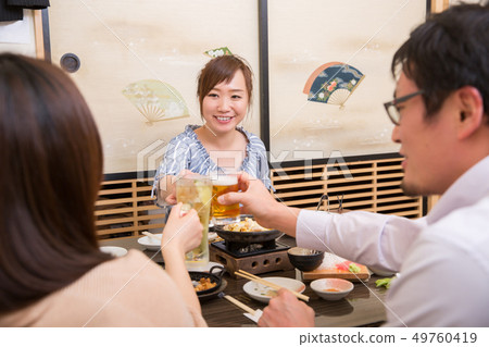 Friends having a drinking party in a tavern 49760419