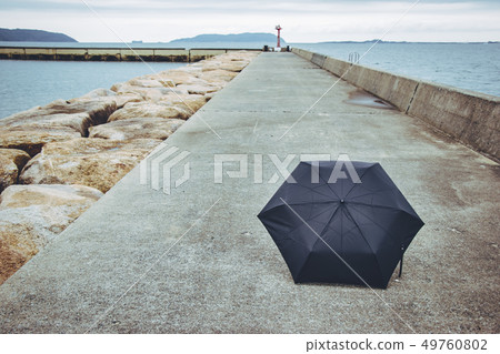 Black umbrella on the foot path way Black umbrella on the foot path way 49760802