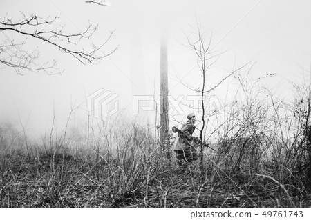 Re-enactor Dressed In Overcoat As World War II Russian Soviet Red Army Soldier Running In Fog Smoke Re-enactor Dressed In Overcoat As World War II Russian Soviet Red Army Soldier Running In Fog Smoke 49761743