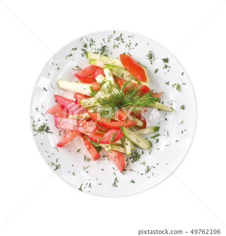 sliced cucumbers and tomatoes on a plate, isolated on white background. Top view 49762106