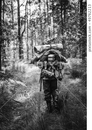 Re-enactor Dressed As German Infantry Soldiers In World War II Marching Walking Along Forest Road In 49762213