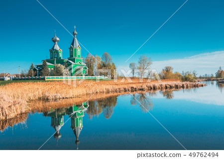 Old Wooden Russian Orthodox Church Near Lake In Early Spring Or Late Autumn Season. Sunny Day Old Wooden Russian Orthodox Church Near Lake In Early Spring Or Late Autumn Season. Sunny Day 49762494