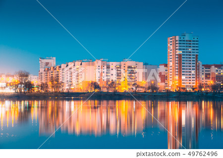 Urban Residential Area Overlooks To City Lake Or River And Park In Evening Illumination, Reflecting 49762496