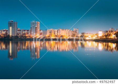 Night View Of Urban Residential Area Overlooks To City Lake Or River And Park In Evening Night View Of Urban Residential Area Overlooks To City Lake Or River And Park In Evening 49762497