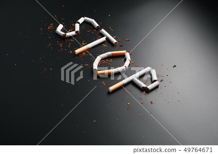 The inscription STOP from cigarettes on a black The inscription STOP from cigarettes on a black 49764671