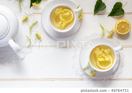 Two cups of linden tea with linden flowers Two cups of linden tea with linden flowers 49764731