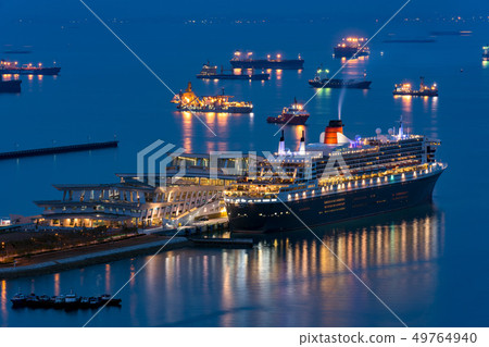 A luxury liner anchored at Singapore port Queen Mary 2 night view 49764940