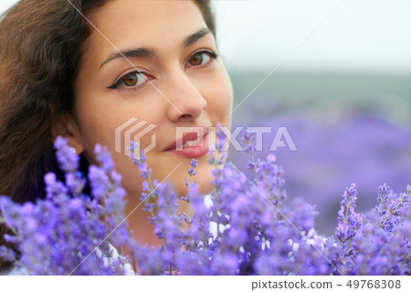 beautiful woman face with lavender flower 49768308