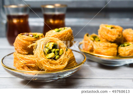 Arabic dessert with pistachio with tea Arabic dessert with pistachio with tea 49768613