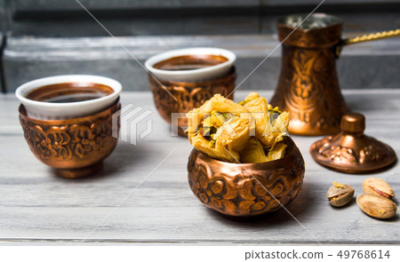 Arabic baklava with coffee in copper cups 49768614