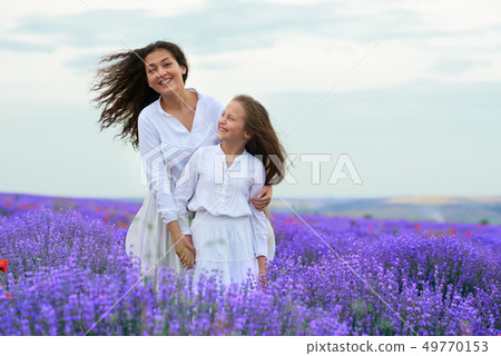 girls are in the lavender flower field, beautiful 49770153