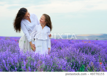 girls are in the lavender flower field, beautiful 49770155