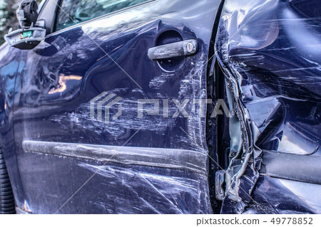 Detail of car after accident, side metal plates deformed after crash hit. Detail of car after accident, side metal plates deformed after crash hit. 49778852