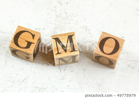 Three wooden cubes with letters GMO stands for Genetically modified organism on white board. Three wooden cubes with letters GMO stands for Genetically modified organism on white board. 49778979