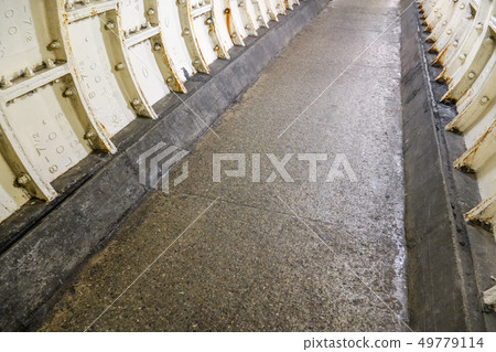 Flat stone floor and heavy iron plating on Thames under water tunnel wall. Flat stone floor and heavy iron plating on Thames under water tunnel wall. 49779114