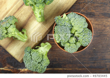 chopped broccoli on a cutting board chopped broccoli on a cutting board 49783445