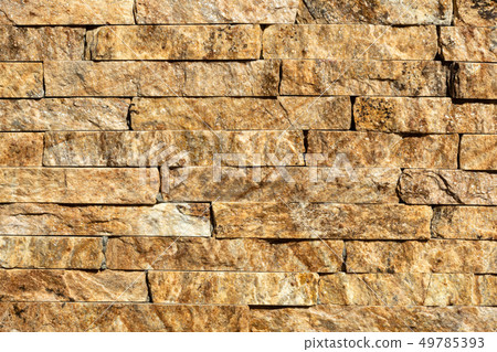 Stone wall of natural stones in different sizes. 49785393