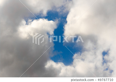 Snow-white fluffy Clouds on a blue sky 49787710