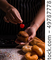 Pastry chef decorating banana cupcake 49787778