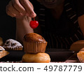 Pastry chef decorating banana cupcake 49787779