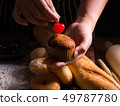 Pastry chef decorating banana cupcake 49787780