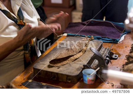 Woman making cigar - Trinidad - Cuba Woman making cigar - Trinidad - Cuba 49787806