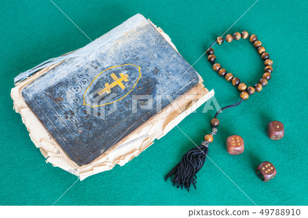 old psalm book, worry beads and three wooden dices old psalm book, worry beads and three wooden dices 49788910